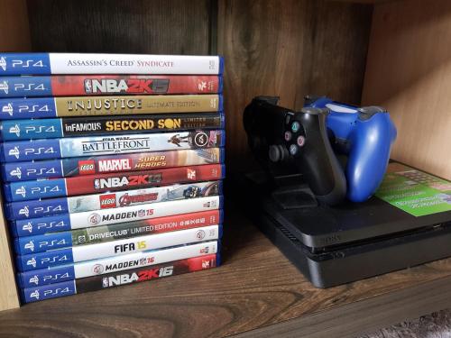 a stack of video game books with a remote control on top at ISLA VILLA 1 amazing waterfall pool house near beach, bars & restaurants in Mactan