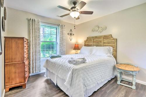 a bedroom with a bed and a ceiling fan at Peaceful Beaufort Home with Front Porch and Grill in Beaufort