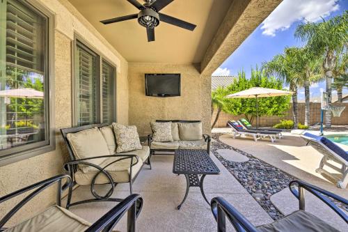 a patio with a couch and chairs and a tv at Pool, Hot Tub and Patio Mesa Oasis Desert Getaway in Mesa