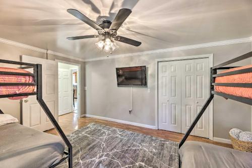 a bedroom with two bunk beds and a ceiling fan at Family-Friendly Sanctuary BBQ, Patio and Yard in Oak Hill
