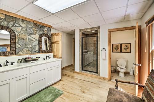 a bathroom with a sink and a toilet at Gorgeous Piney Creek Cabin with River Access! in Piney Creek