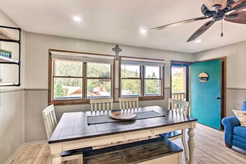 a dining room with a table and a ceiling fan at Main St Red River Ski Condo with Mountain View! in Red River