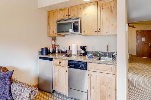 a kitchen with a sink and a microwave at Grand Lodge 369 in Crested Butte