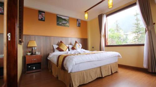 Postel nebo postele na pokoji v ubytování Heart Of Sapa Hotel