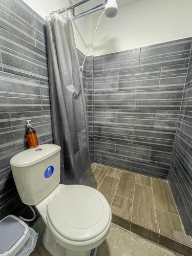 a bathroom with a toilet and a shower at The Stay Inn in San José