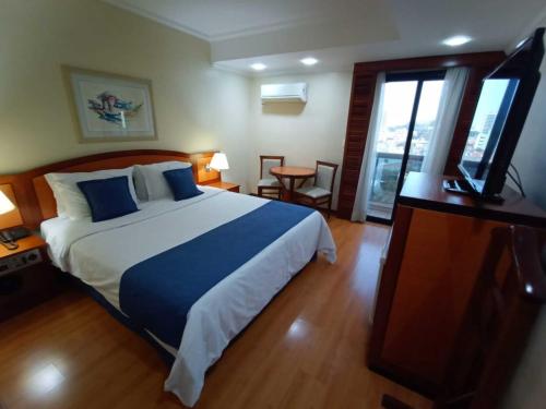 Łóżko lub łóżka w pokoju w obiekcie Summit Suítes Hotel Jundiaí