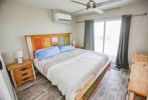 a bedroom with a large bed and a window at Beachfront Retreat! 3 Steps to WALKOVER! in Surfside Beach