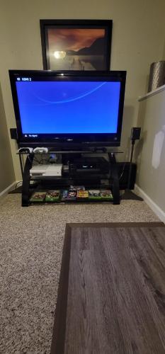 a flat screen tv sitting on a stand in a living room at Hidden Gem near Downtown Frederick and shopping in Frederick
