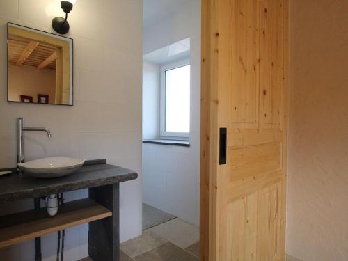 a bathroom with a sink and a wooden door at Gîte Saint-Jeures, 5 pièces, 11 personnes - FR-1-582-43 in Saint-Jeures