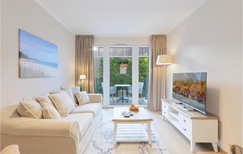 a living room with a couch and a tv at Baltischer Hof Apartment 23 in Boltenhagen