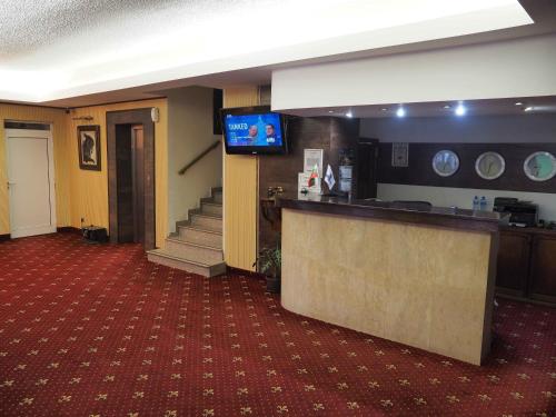 a living room filled with furniture and a tv at Bononia Hotel in Vidin