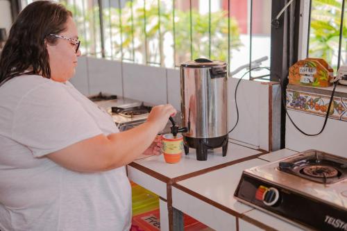 a woman standing in a kitchen with a blender at Rio Danta in Fortuna