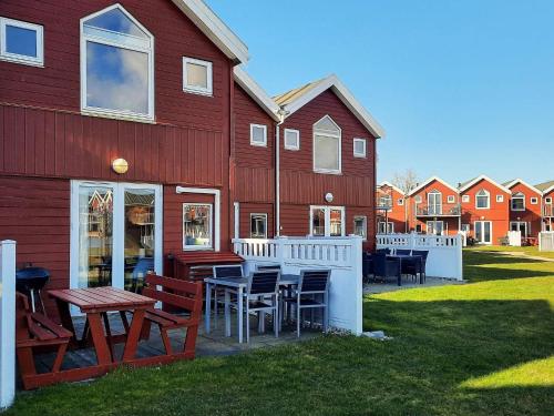 a red building with tables and chairs in front of it at 6 person holiday home in Hadsund-By Traum in Hadsund