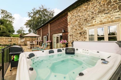 a hot tub in the backyard of a house at Lake View in Crediton