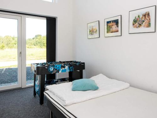 a room with a bed and a window and a table at Holiday home Glesborg L in Glesborg