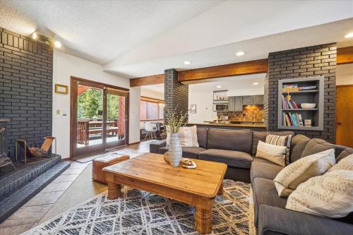 a living room with a couch and a table at Twins Getaway at Meadow Creek Duplex in Frisco