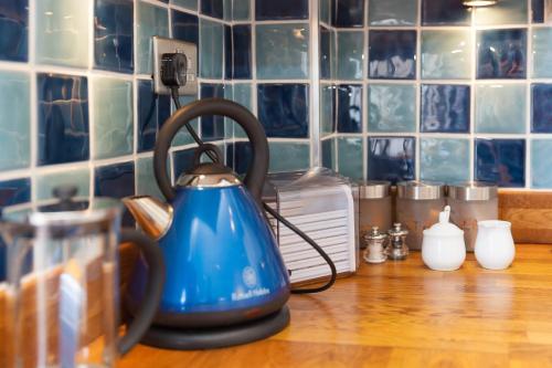 a blue tea kettle on a counter in a kitchen at Atlantic Waves in Carbis Bay