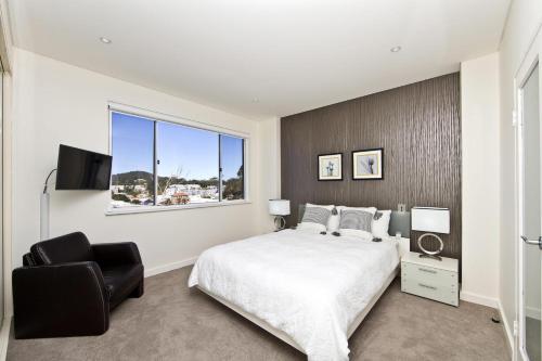 a bedroom with a large bed and a window at Penthouse Palace - Luxurious Harbourview Location in Nelson Bay