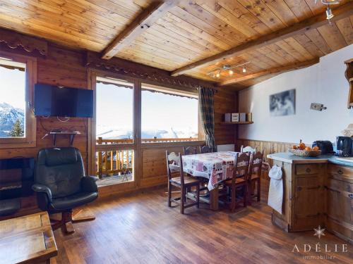 a kitchen and dining room with a table and chairs at Appartement Montvalezan-La Rosière, 2 pièces, 5 personnes - FR-1-398-649 in Montvalezan