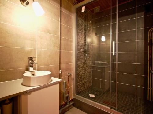 a bathroom with a sink and a shower at Appartement Chamrousse, 3 pièces, 8 personnes - FR-1-549-108 in Chamrousse