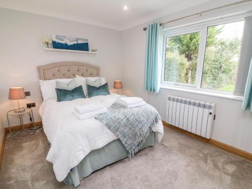 a bedroom with a bed and two windows at 2 Bedroom Annexe in Morecambe