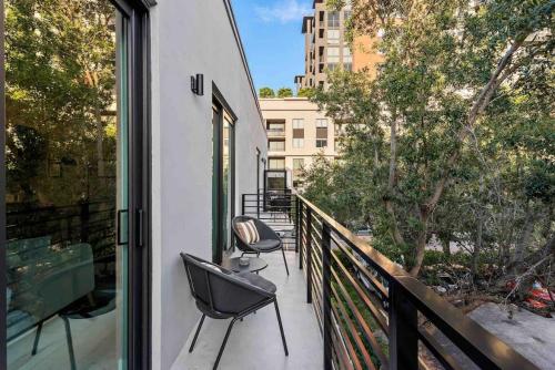 a balcony with two chairs and a large window at Pretty Rola 303 Signature Apartment w King Bed Brand new and Central Location in Fort Lauderdale