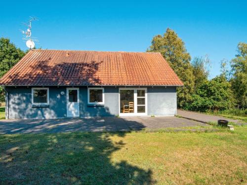 a small house with an orange roof at 11 person holiday home in Ørsted-By Traum in Ørsted