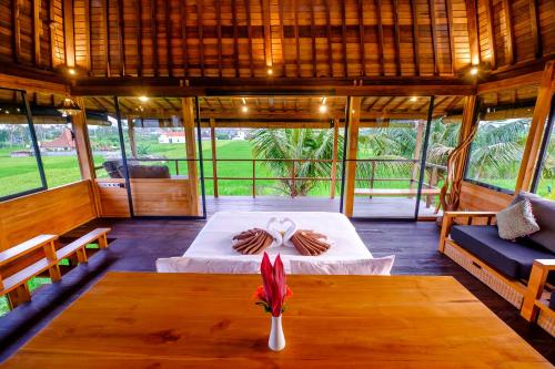 a person standing on a bed in a room at Canggu Wooden Green Paradise in Canggu