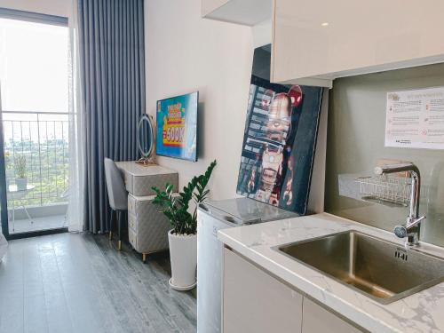 a small kitchen with a sink and a window at Apartment 1BR-FL12th-R103 Building-Vinhome Ocean Park in Hanoi