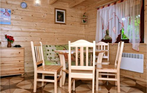 a wooden dining room with a table and chairs at 2 Bedroom Stunning Home In Sianozety in Sianozety