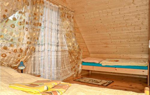 a bedroom with a bed in a wooden cabin at 2 Bedroom Stunning Home In Sianozety in Sianozety