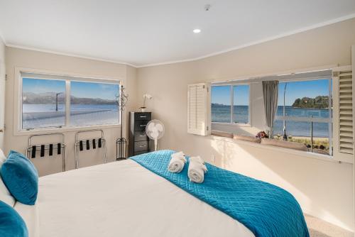 a bedroom with a bed with two towels on it at Waterfront Apartments Whitianga in Whitianga