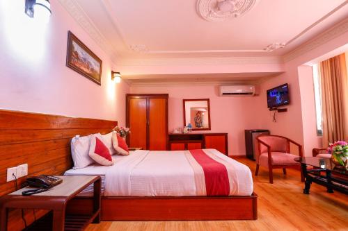 a hotel room with a bed and a table at Hotel Blue Horizon in Kathmandu