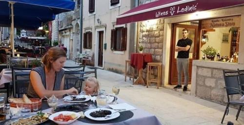 a woman sitting at a table with a baby at a restaurant at Rooms with WiFi Ston, Peljesac - 19339 in Ston