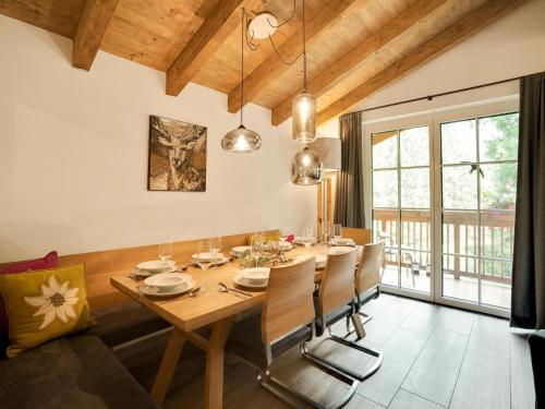 a dining room with a wooden table and chairs at Luxurious holiday home with sauna in Krimml