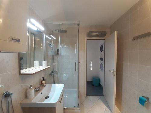a bathroom with a shower and a sink and a toilet at Apartments by the sea Vantacici, Krk - 19306 in Malinska