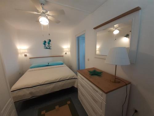 a bedroom with a bed and a table with a lamp at Apartments by the sea Vantacici, Krk - 19306 in Malinska