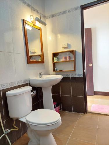 a bathroom with a toilet and a sink at Villa Rattanakon in Luang Prabang
