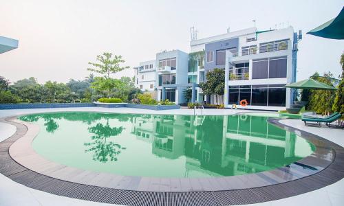 a large swimming pool in front of a building at SKS Inn 