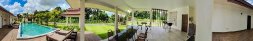 a house with a swimming pool and a patio at Isan Golf & Adventure Hotel in Udon Thani