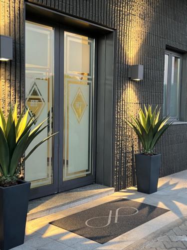 a front door of a building with two potted plants at Hotel Motel Top in Cusago