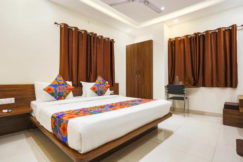 a bedroom with a large bed in a room at FabHotel Balaji Paradise in Indore