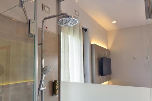 a bathroom with a shower and a mirror at Casa Antonelli in Malcesine