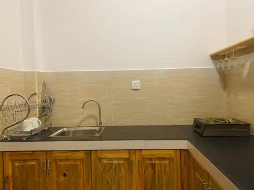 a kitchen with a sink and a counter top at The Cozy Nest in Hikkaduwa