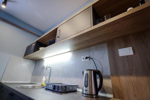 a coffee pot sitting on a counter in a kitchen at Domaćin Komšijska Gostiona in Zrenjanin