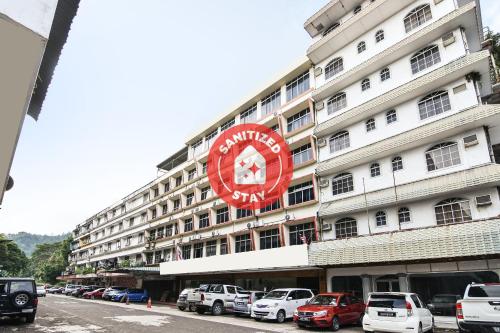 a large white building with a red sign on it at Hotel Hsiang Garden in Sandakan