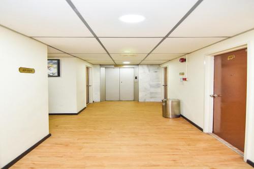 an empty hallway in an office building with a wooden floor at Hotel Hsiang Garden in Sandakan