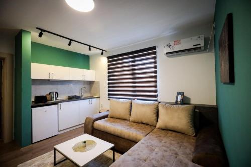 a living room with a couch and a table at Domaćin Komšijska Gostiona in Zrenjanin