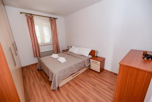 a bedroom with a bed with two towels on it at Villa Heaven in Donji Zemunik