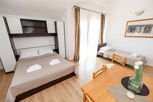 a small room with two beds and a table at Villa Heaven in Donji Zemunik